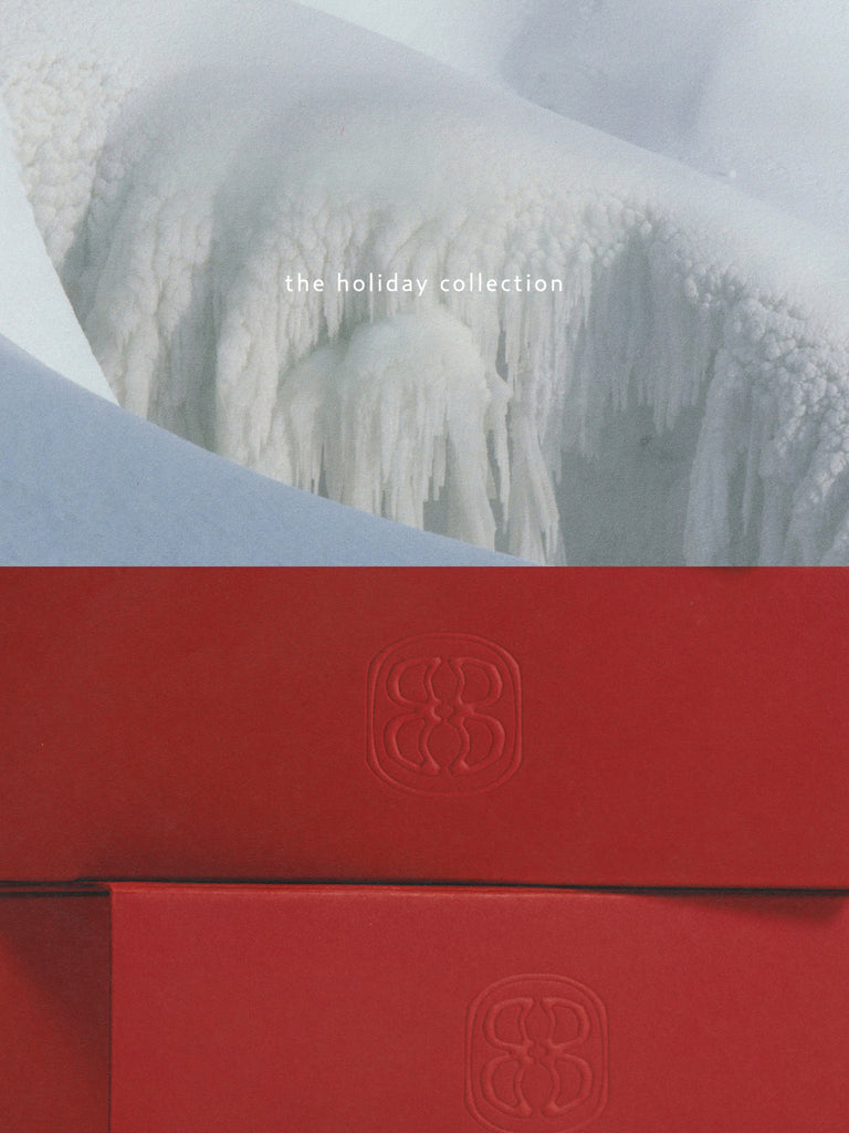 Red box with a logo on a snowy mountain background , text on image reading The holiday collection